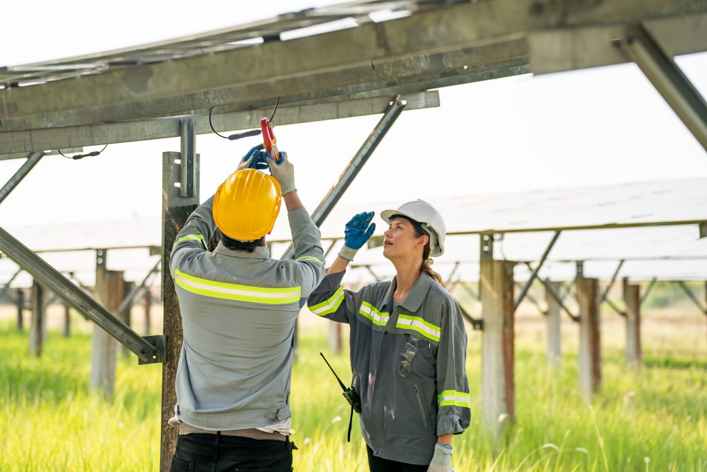 photovoltaic panel, Engineer with energy measurement tool photovoltaic modules for energy