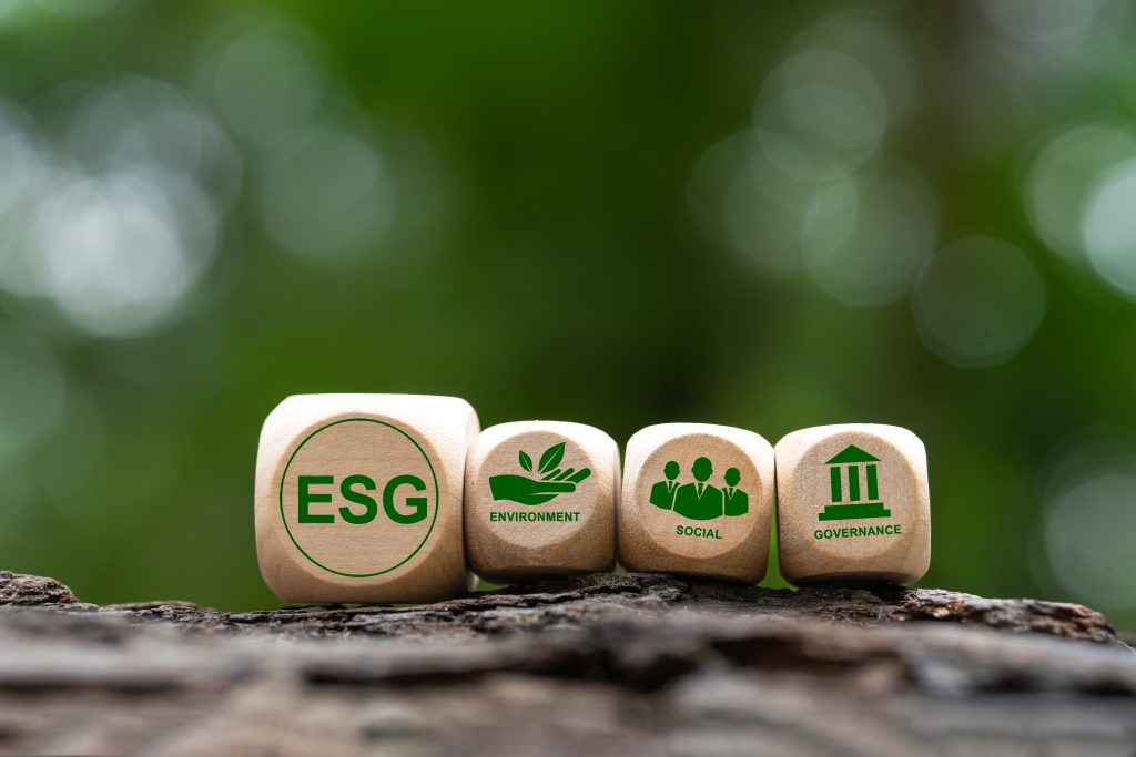 Esg icons on green background wooden blocks